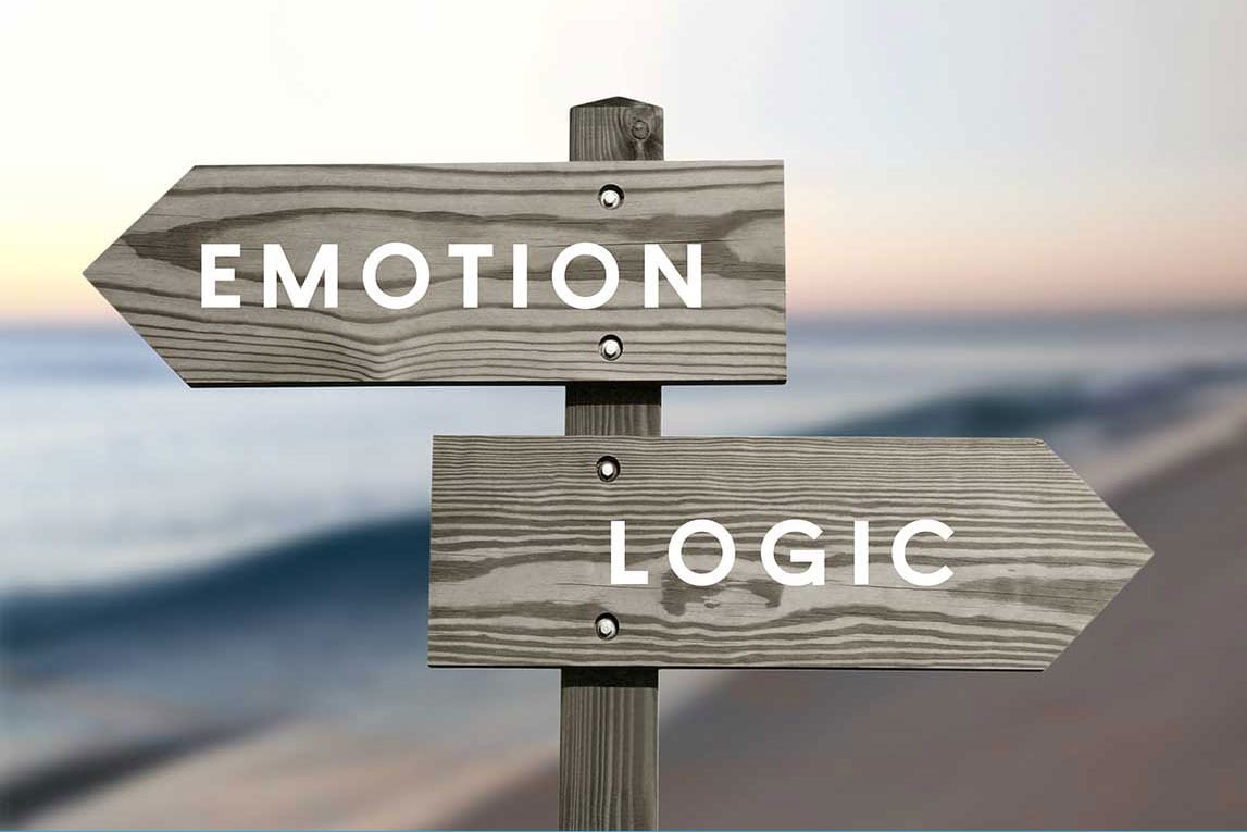 Wooden signpost with EMOTION and LOGIC in reference to emotional home buying